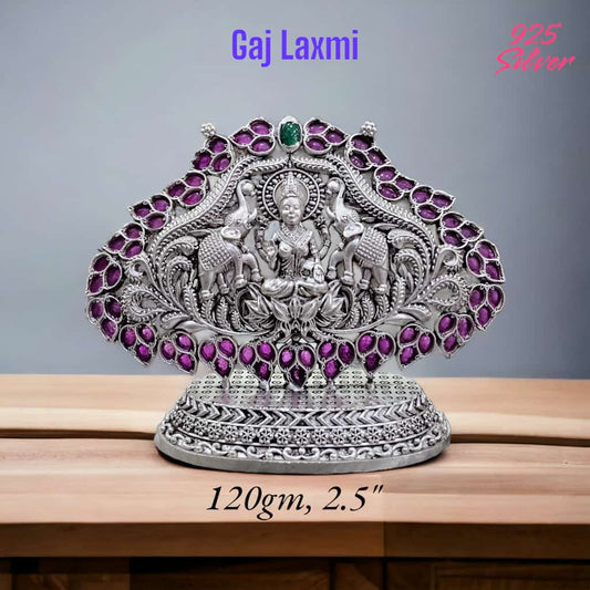 Intricately designed 925 silver Gaja Laxmi idol with purple and green gemstone accents on a decorative base