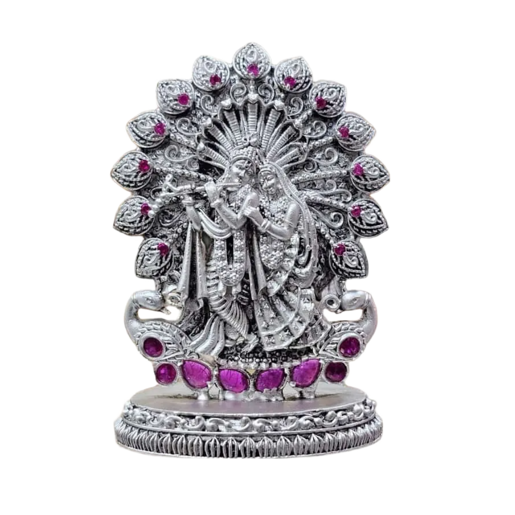925 silver Radha Krishna idol with intricate detailing and pink gemstone accents on a decorative base