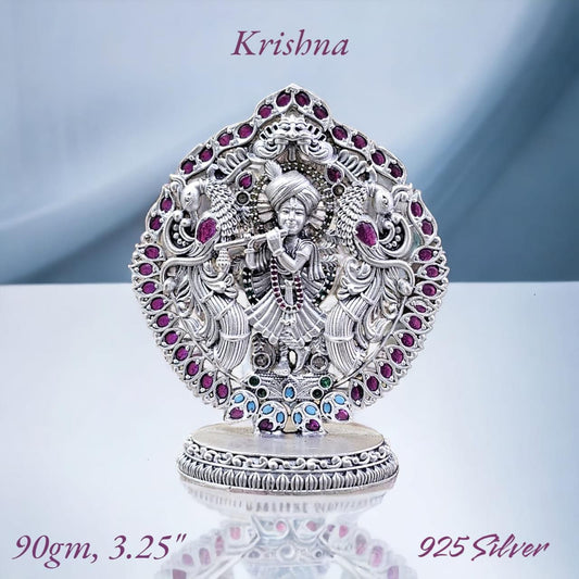 Pure silver Krishna murti for puja adorned with colorful gemstones and intricate detailing by RudraShiv Blessing