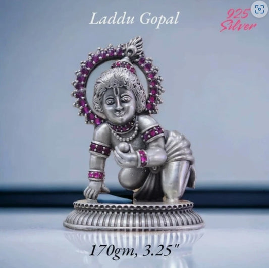 925 silver Laddu Gopal idol with intricate design and purple embellishments on a decorative base