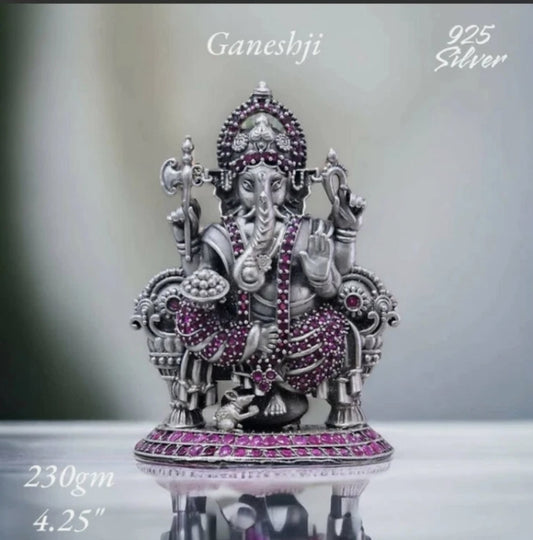 Pure 925 silver ganesh idol adorned with purple stones sitting on a throne with intricate detailing
