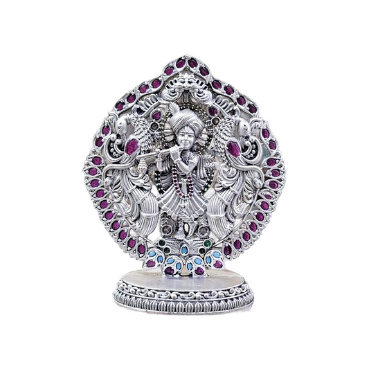 Pure silver Krishna murti for puja adorned with colorful gemstones and intricate craftsmanship