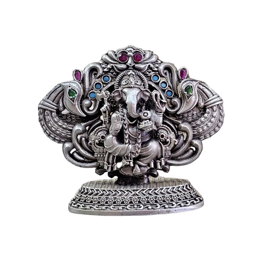 Intricately designed pure silver Lord Ganesha statue with colorful gemstone accents on decorative base